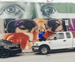 Cars parked on a wall with art