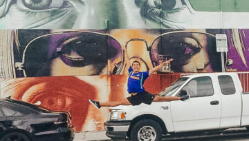 Cars parked on a wall with art